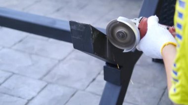 Man doing metal work using hand cutting machine tool