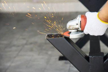 Man doing metal work using hand cutting machine tool