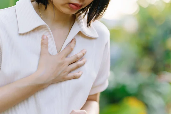 A woman has chest pain. Possible signs of acute myocardial infarction or Heart Attack. Health care concept.