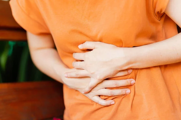 Stock image Women have abdominal pain due to menstruation or gastritis. Concept of health problems.