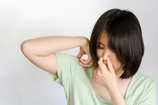 女人用手捂住鼻子 因为腋窝里有汗水的味道 — 图库照片