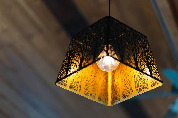 The golden light pendant ceiling lamp has a square iron frame in a modern shape. Home decoration ideas.