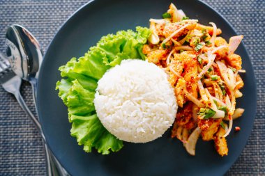 Tabakta pirinçli baharatlı tavuk salatası lezzetli ve baharatlı bir Tayland yemeğidir..