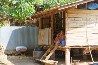 Mae Sot, Tak, Tayland - 2 Nisan 2023: Yaşlı bir kadın kulübesinde yalnız oturuyor.