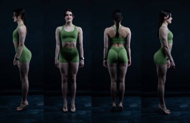 İç çamaşırlı kadın karanlık stüdyoda poz veriyor..