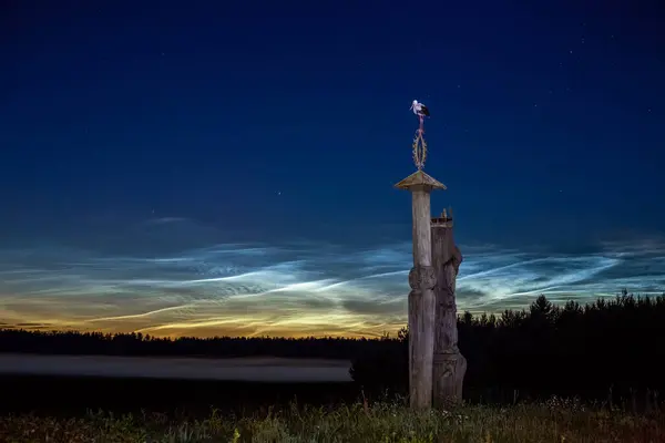 stock image Noctilucent clouds in the fields of the Lithuanian countryside with sculptures on the ''M.K. Ciurlionis road'' near the village of Perloja