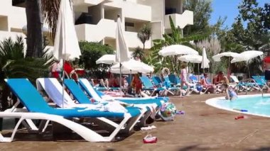 Dorada Sarayı 'ndaki havuzda yürüyen ve güneşlenen insanların fotoğrafları. Yüksek kaliteli FullHD görüntüler