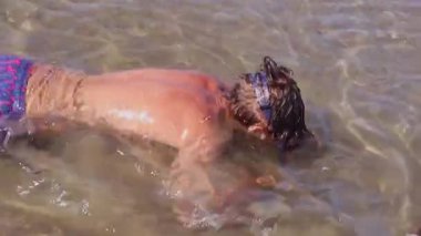 Gençler yüzme maskesiyle denize açılıyor. Gençler yaz tatilinde suda eğleniyor. Yaz tatili ve tatil konsepti. Yüksek kaliteli FullHD görüntüleri.