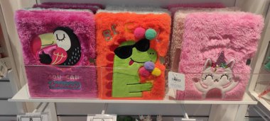 Benidorm, İspanya - 31 Mayıs 2025: AleHop shop. Bir tukan, dinozor ve tek boynuzlu atın da dahil olduğu çizgi film tasarımlarıyla dolu pelüş defterler perakende rafında sergilenerek yaratıcılığa ve eğlenceye davetiye çıkarıyor.