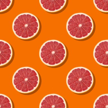 Turuncu arka planda renksiz turunçgil dilimleri. Yaratıcı meyve konsepti. Renkli greyfurt yemek arka planı. Yüksek kalite fotoğraf