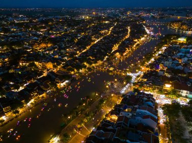 Panoramic aerial drone view of Hoi An Ancient town with boat tour and beautiful lanterns in evening. UNESCO world heritage. One of the most travel popular touristic destinations