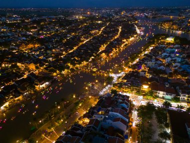 Panoramic aerial drone view of Hoi An Ancient town with boat tour and beautiful lanterns in evening. UNESCO world heritage. One of the most travel popular touristic destinations
