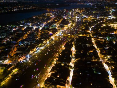 Panoramic aerial drone view of Hoi An Ancient town with boat tour and beautiful lanterns in evening. UNESCO world heritage. One of the most travel popular touristic destinations