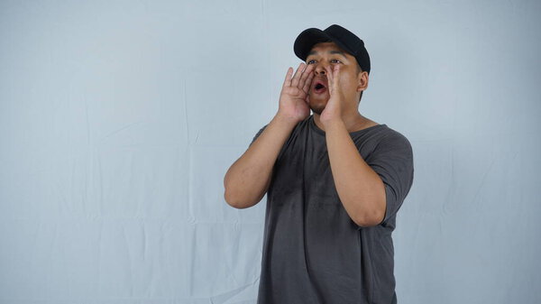 Young asian man yawning with hand on his face