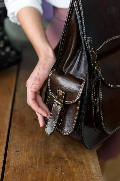 stock image part photo of a brown leather backpack. Indoor photo