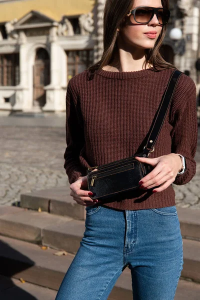 Young Brunette Posing Jeans Knitted Sweater Small Brown Belt Bag — стоковое фото