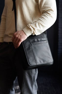 close-up photo of black leather bag. outdoors photo