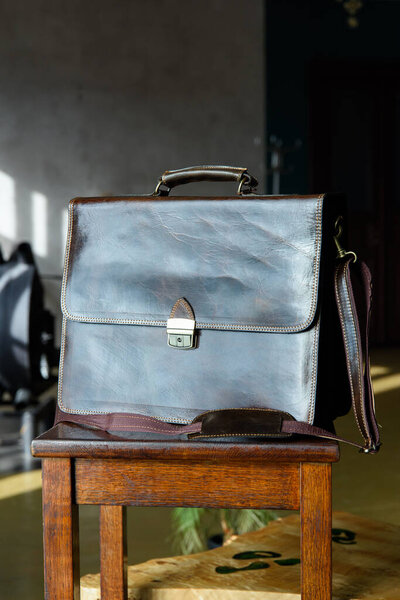 close-up photo of brown leather bag corporate. Indoor photo