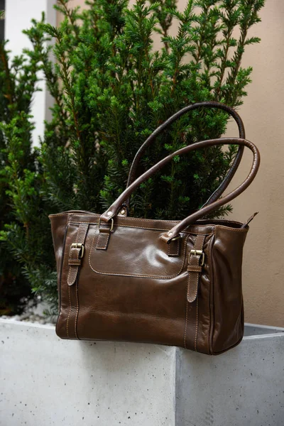 Close Photo Brown Leather Bag Flowerpot Made Cement Outdoors Photo — Stock Photo, Image