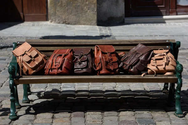 Group Leather Backpacks Different Colours Wooden Bench — Stock Photo, Image