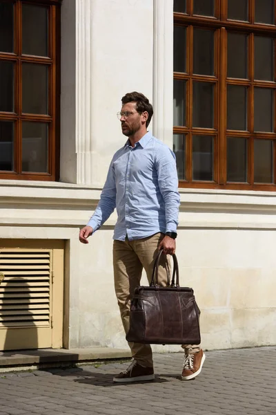 stock image Handsome businessman walking on the street, with luxury leather briefcase. Fashionable style. Street photo