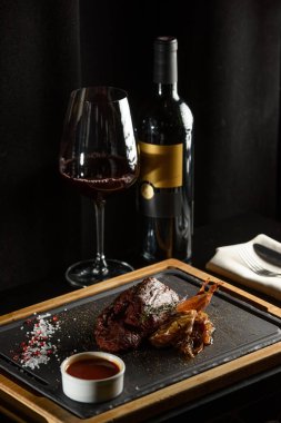 Lezzetli ızgara biftek, kırmızı şarap, baharatlar, taze biberiye ve ızgara sebze..