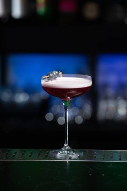 Bulanık arka planda yeşil ve beyaz Bokeh ışıkları ipuçları içeren koyu tonlar var. Bu da şık bir bar ayarına işaret ediyor.