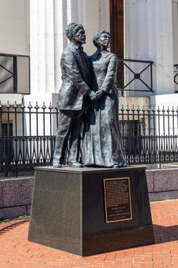 ST. LOUIS, MISSOURI USA - OCTOBER 5, 2024: A statue of Dred and Harriet Scott, former slaves, in front of the Old Courthouse where they sued unsuccessfully for their freedom. clipart