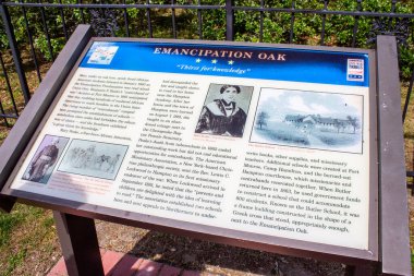 HAMPTON, VA - MAY 25, 2014:  Sign display for Emancipation Oak, a historic tree on the campus of Hampton University, where African Americans heard the reading of the Emancipation Proclamation. clipart