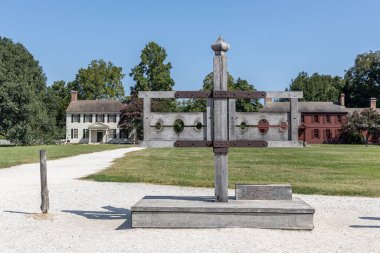 A pillory, also known as stocks, outside the courthouse in Colonial Williamsburg clipart