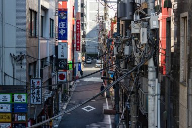 Tokyo, Japonya, 26 Ekim 2023: Yoğun İşaret ve Elektrik Kablolarıyla Dar Sokak