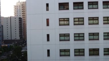 Tokyo, Japonya, 22 Kasım 2023: Pencereleri desenli modern bir ofis binasının cephesi