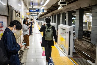 Tokyo, Japonya, 27 Ekim 2023: Tokyo metro istasyonunda bekleyenler