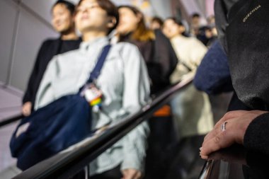 Tokyo, Japonya, 27 Ekim 2023: Tokyo metrosundaki yürüyen merdivende seyahat edenler
