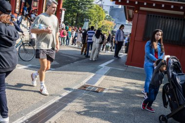 Tokyo, Japonya, 28 Ekim 2023: Gezgin Arabalı Genç Kadın Kırmızı Torii Kapısı 'ndan Geçiyor