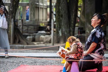 Tokyo, Japonya, 28 Ekim 2023: Maymun ve antrenörle sokak performansı
