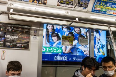 Tokyo, Japonya, 29 Ekim 2023: Metro reklamları ve yolcuları