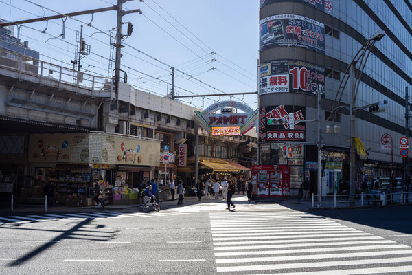 Tokyo, Japan, 30 October 2023: Sunlit street view with the entrance to Ameya-Yokocho market