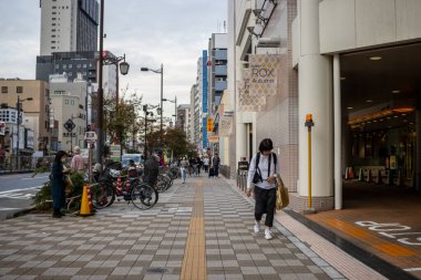 Tokyo, Japonya, 31 Ekim 2023: Bir alışveriş merkezinin girişinde yürüyen yayalar