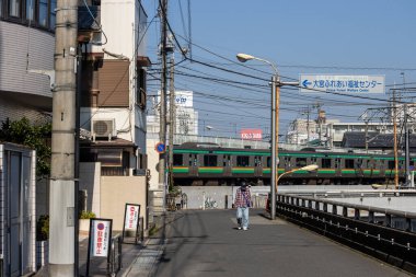 Tokyo, Japonya, 3 Kasım 2023: Nippori istasyonu yakınlarındaki yerleşim alanından geçen tren