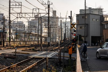 Tokyo, Japonya, 3 Kasım 2023: Bisikletli ve arabalı tren rayları ve geçidi