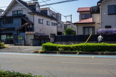 Tokyo, Japonya, 3 Kasım 2023: Yaya ve geleneksel Japon evleriyle şehir sokak sahnesi