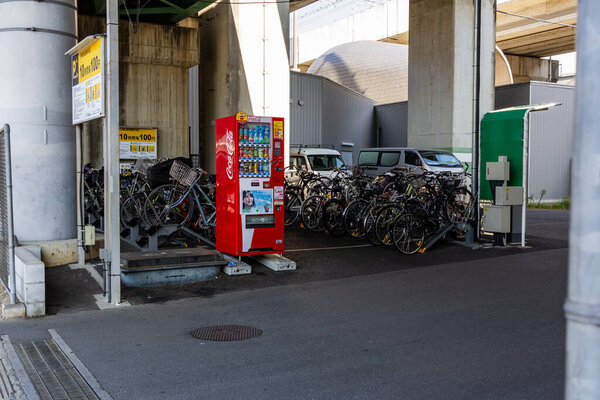 Tokyo, Japan, 3 November 2023: Vending machines and bicycles under an overpass