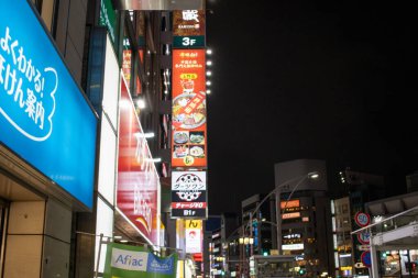 Tokyo, Japan, November 6, 2023 : Night View of Urban Street with Illuminated Signboards clipart