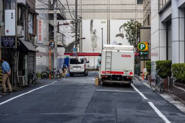 Tokyo, Japan, 6 November 2024 : Urban Street Scene with Billboards and Delivery Truck clipart