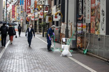 Tokyo, Japan, 6 November 2024 : Urban Street Scene with Local Businesses and Pedestrians clipart