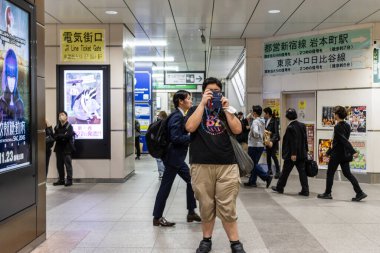 Tokyo, Japonya, 6 Kasım 2024: Yoğun bir metro istasyonunda fotoğraf çekimi