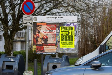 France, 22 March 2024: Urban Scene with Posters and No Parking Sign clipart