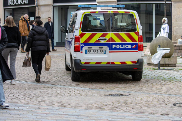 France, 30 March 2024: Police vehicle patrolling in a busy street