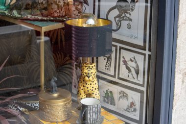 France, 10 March 2024: Antique Storefront Window Display with Art Illustrations clipart